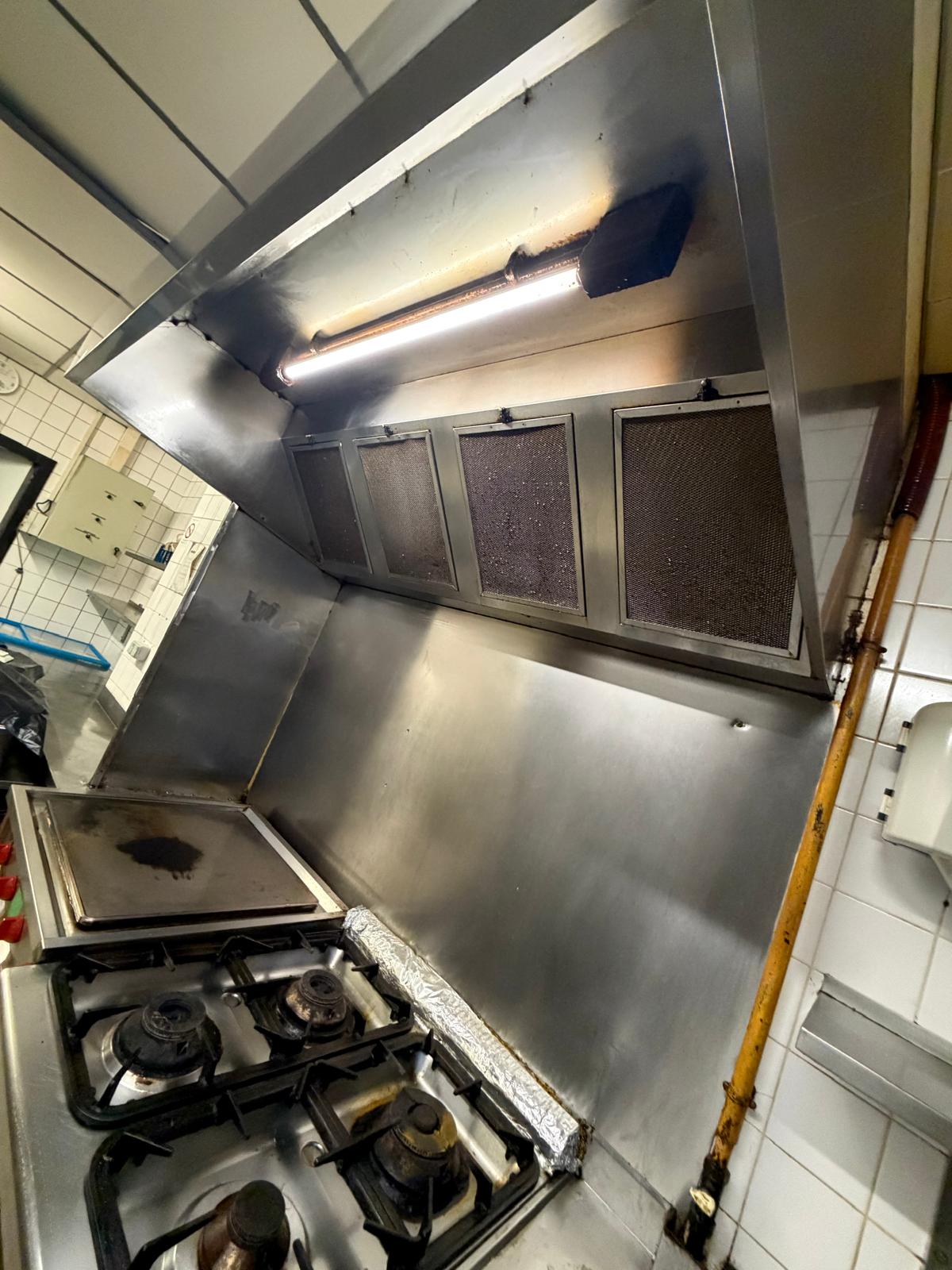 Hotte de cuisine professionnelle très encrassée avec dépôts de graisse avant entretien technique